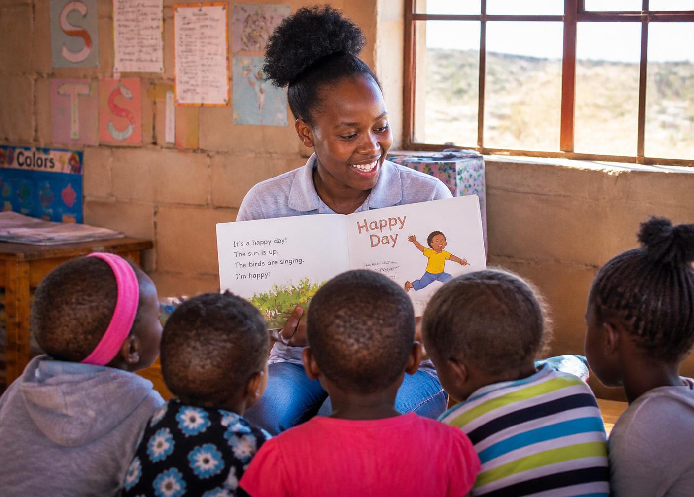 A trained caregiver reading a picture book to preschool children